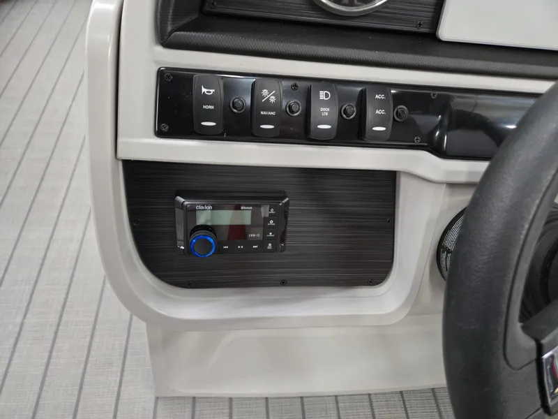 Slide: The Image of Control panel of 2025 Godfrey Sweetwater 2286 FS boat with switches and stereo system. - 11