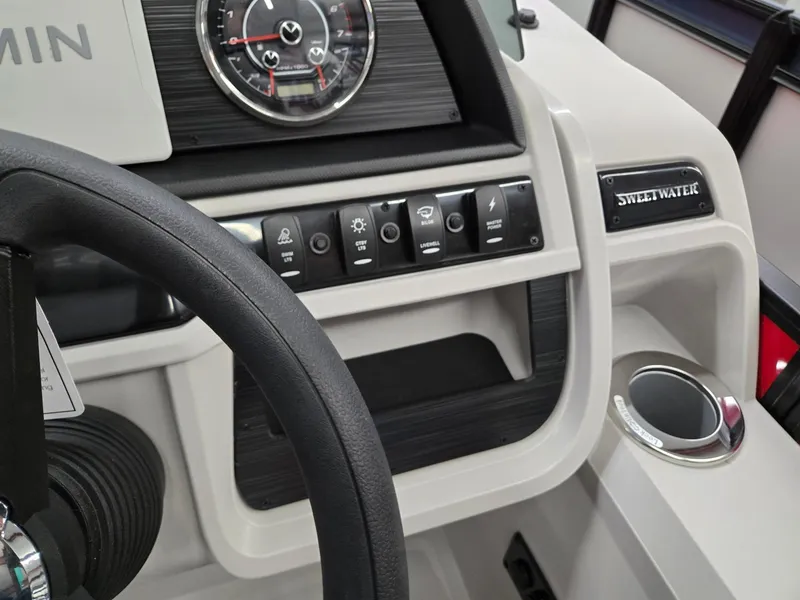 Slide: The Image of Dashboard of 2025 Godfrey Sweetwater 2286 FS boat with steering wheel and control panel. - 12