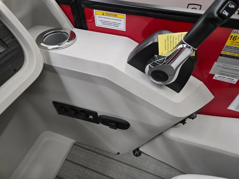 Slide: The Image of Control panel of 2025 Godfrey Sweetwater 2286 FS boat with throttle and cup holder. - 13