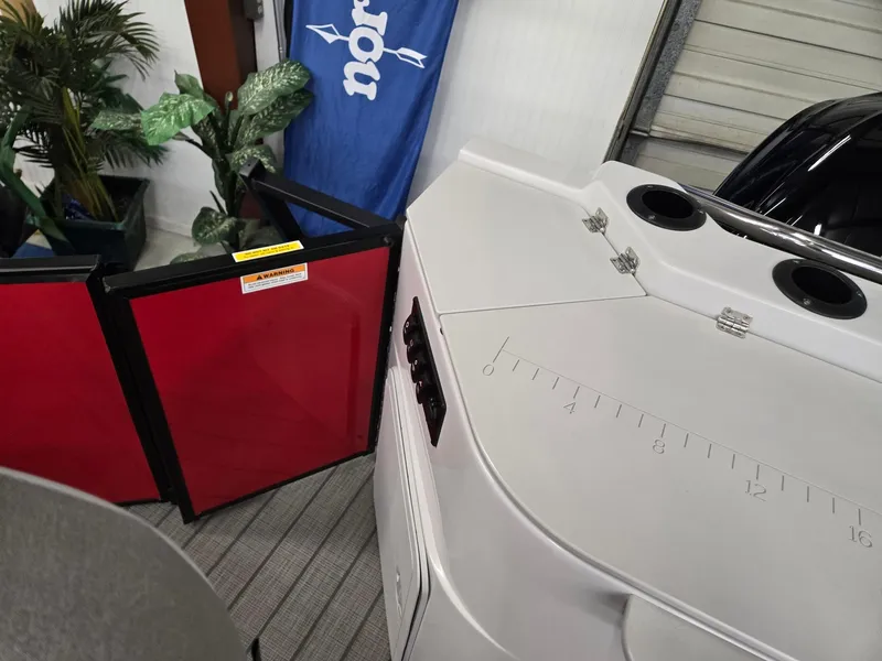 Slide: The Image of 2025 Godfrey Sweetwater 2286 FS boat interior with red panels and plants. - 20