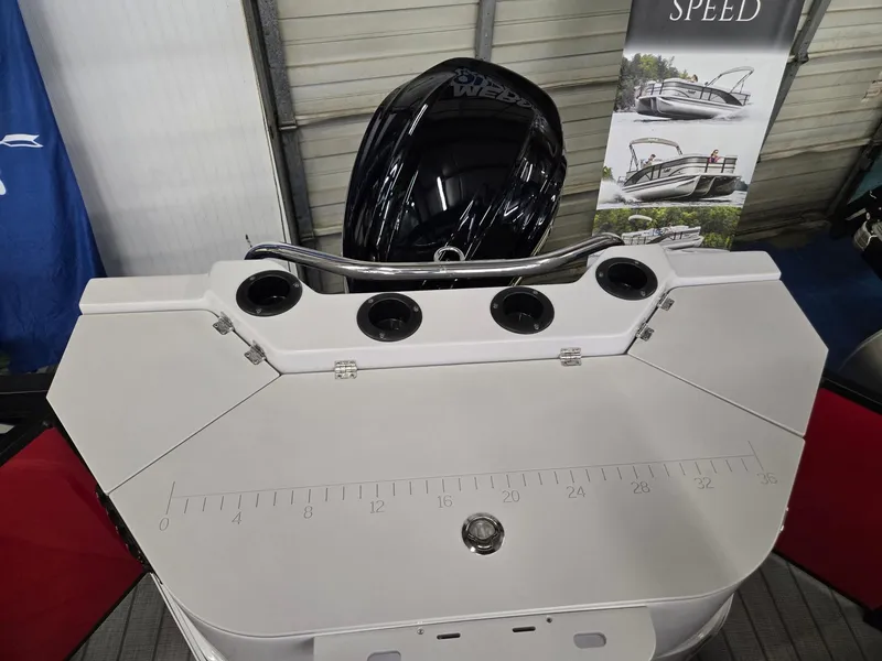 Slide: The Image of 2025 Godfrey Sweetwater 2286 FS boat deck with motor and fishing rod holders. - 21