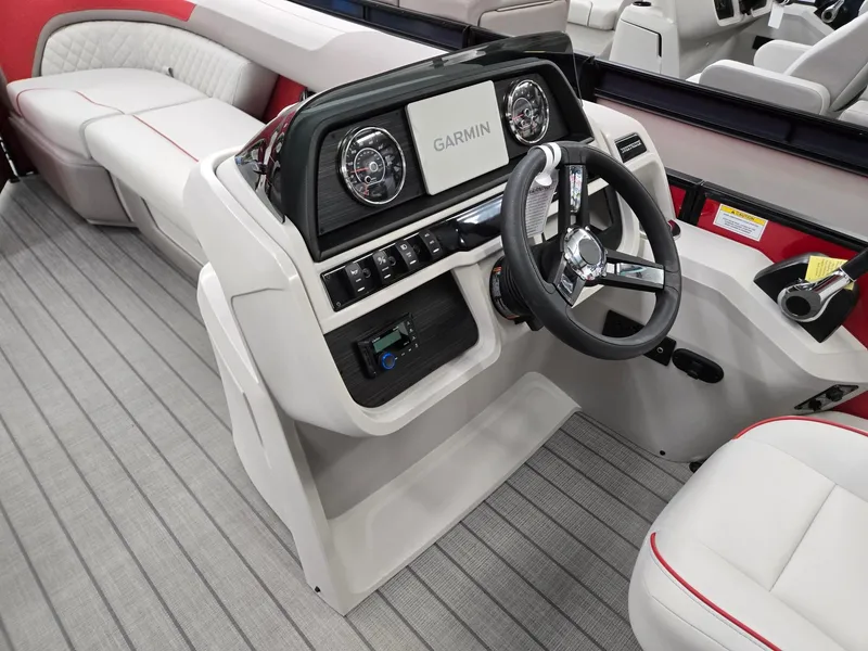 Slide: The Image of 2025 Godfrey Sweetwater 2286 FS boat interior with Garmin dashboard and steering wheel. - 27