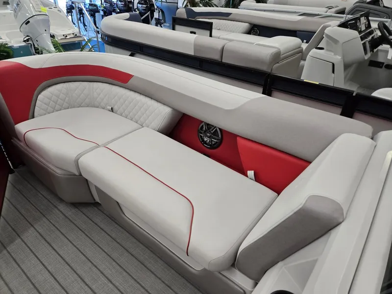 Slide: The Image of 2025 Godfrey Sweetwater 2286 FS boat interior with red and gray seating. - 29
