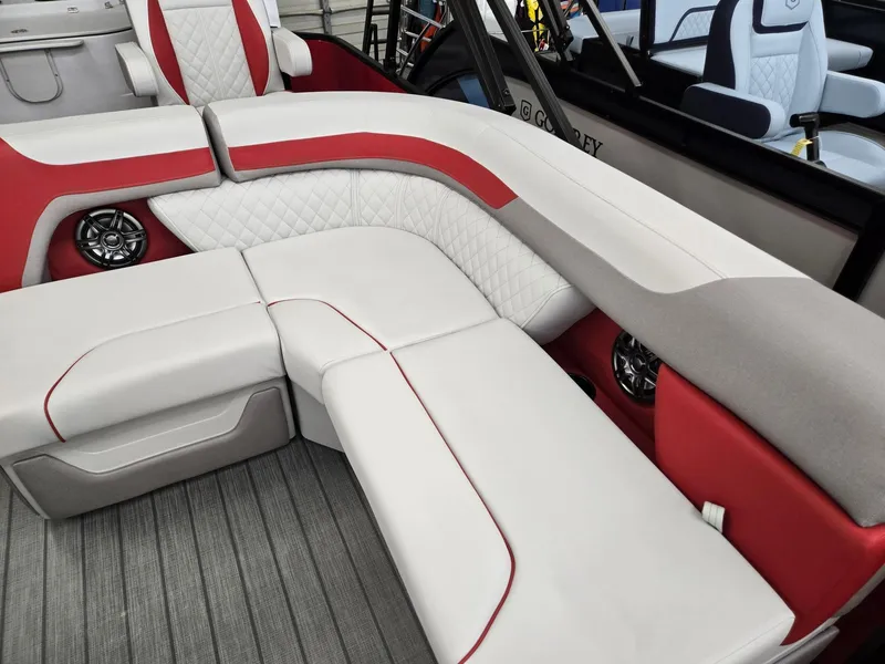 Slide: The Image of 2025 Godfrey Sweetwater 2286 FS boat interior with red and white seating and speakers. - 7