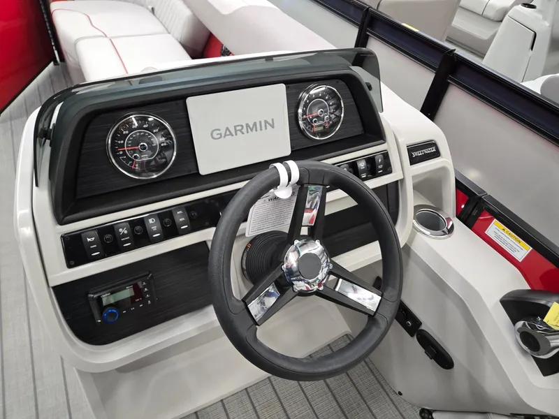 Slide: The Image of 2025 Godfrey Sweetwater 2286 FS boat dashboard with Garmin display and steering wheel. - 9