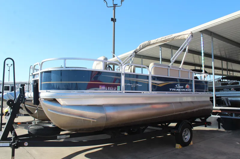 The Image of 2024 Sun Tracker BB18 pontoon boat on trailer in marina. - 1