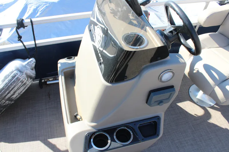 Slide: The Image of 2024 Sun Tracker BB18 boat console with steering wheel and cup holders. - 11
