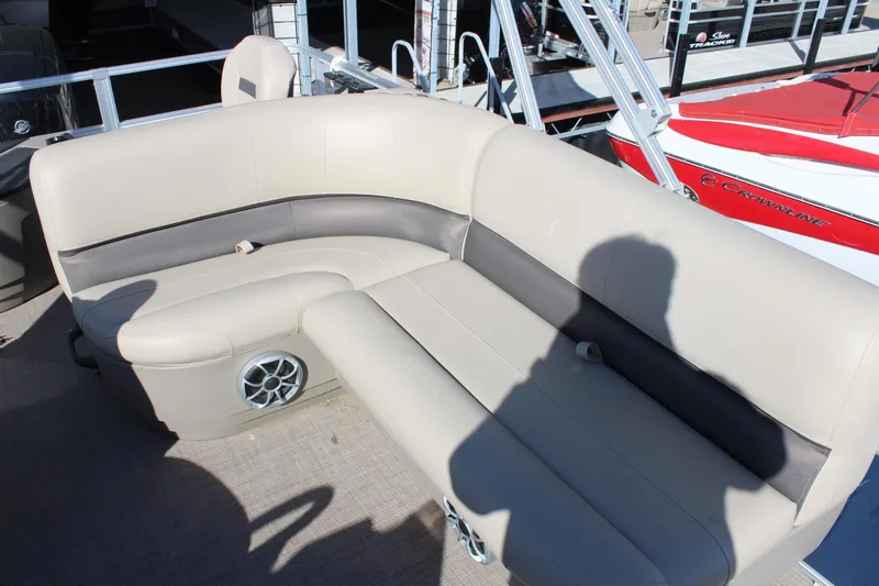 Slide: The Image of 2024 Sun Tracker BB18 boat interior with beige seating and speaker. - 12
