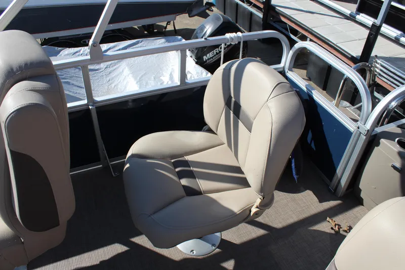Slide: The Image of 2024 Sun Tracker BB18 boat interior with beige seating and railing. - 14