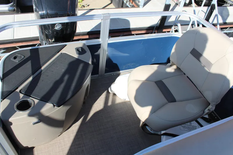 Slide: The Image of 2024 Sun Tracker BB18 boat interior with beige seating and console. - 15