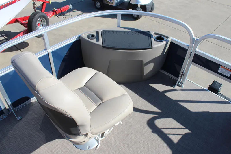 Slide: The Image of 2024 Sun Tracker BB18 boat interior with beige seating and cup holders. - 8