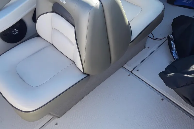 Slide: The Image of 2005 Sea Ray 200 SLX boat interior with beige seating and speaker. - 11