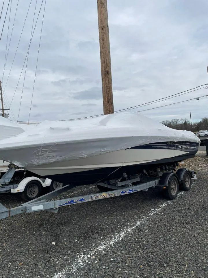 Slide: The Image of 2005 Sea Ray 200 SLX boat on trailer, covered, parked outdoors. - 3