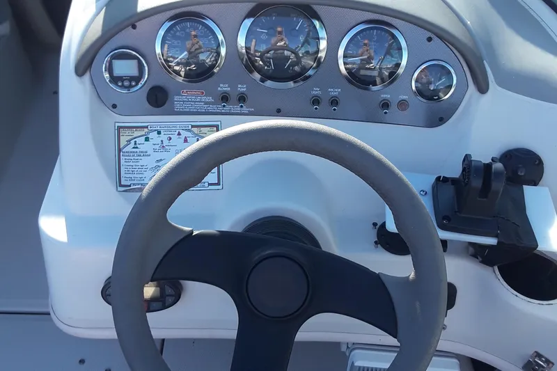 Slide: The Image of 2005 Sea Ray 200 SLX dashboard with steering wheel and instrument panel. - 6