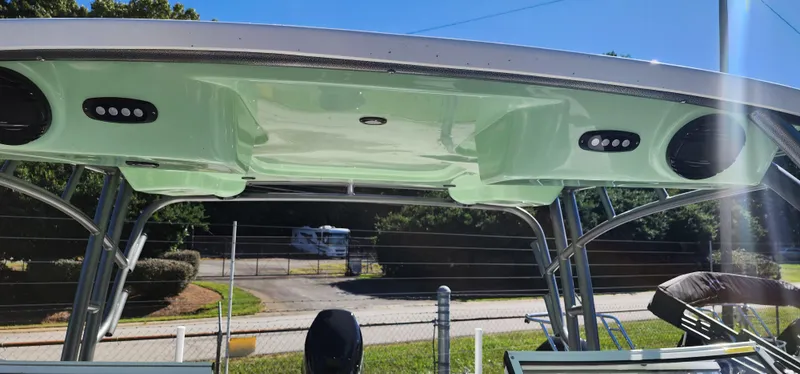 Slide: The Image of 2025 Sea Pro 240 Sport boat canopy with integrated speakers, outdoor setting. - 13