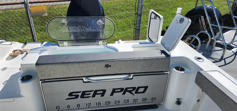 Slide: The Image of 2025 Sea Pro 240 Sport boat interior with storage compartments and measuring scale. - 14