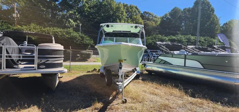 Slide: The Image of 2025 Sea Pro 240 Sport boat on trailer, surrounded by other boats, sunny day. - 4
