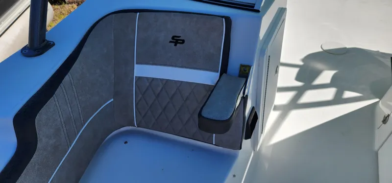 Slide: The Image of 2025 Sea Pro 240 Sport boat interior with cushioned seating and armrest. - 7