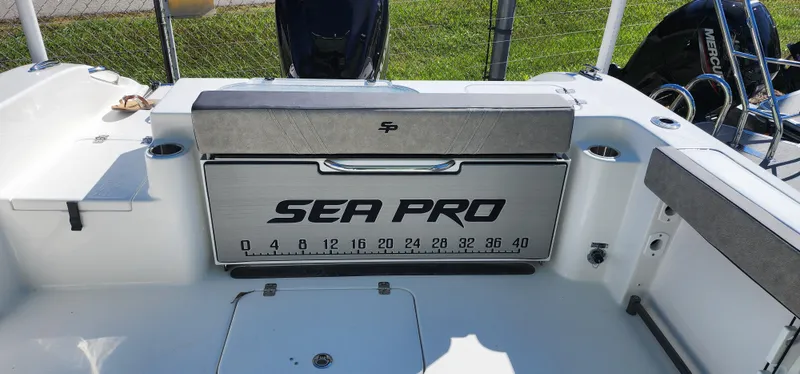 Slide: The Image of 2025 Sea Pro 240 Sport boat interior with branded storage and measurement markings. - 9