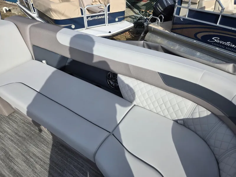 Slide: The Image of 2025 Godfrey Sweetwater 2286 C boat interior with gray cushioned seating. - 10