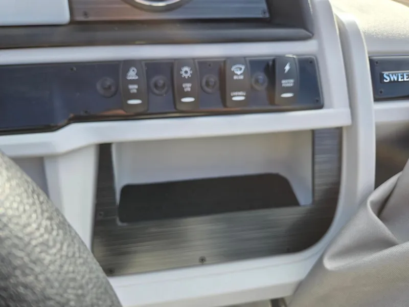 Slide: The Image of Control panel of 2025 Godfrey Sweetwater 2286 C boat with various switches. - 16