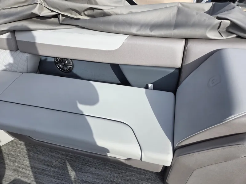 Slide: The Image of 2025 Godfrey Sweetwater 2286 C boat interior with gray seating and speaker. - 19