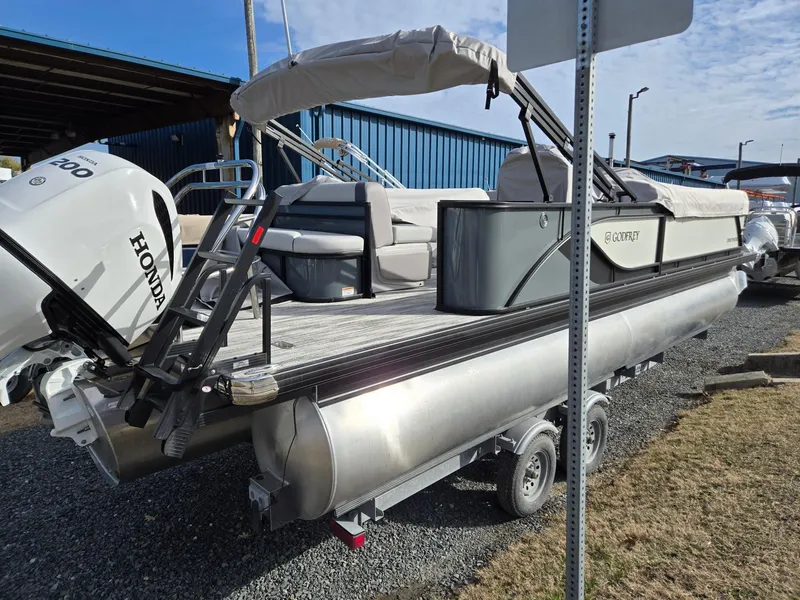 Slide: The Image of 2025 Godfrey Sweetwater 2286 C pontoon boat with Honda engine, parked on a trailer. - 2