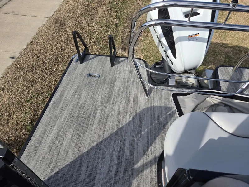 Slide: The Image of 2025 Godfrey Sweetwater 2286 C boat deck with motor and railing. - 21