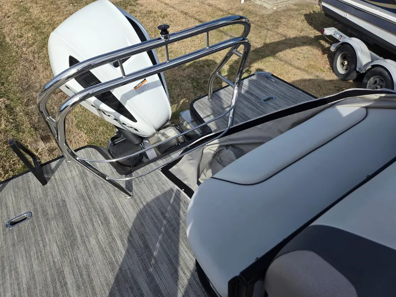 Slide: The Image of 2025 Godfrey Sweetwater 2286 C boat with outboard motor and seating area. - 22