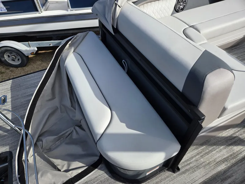 Slide: The Image of 2025 Godfrey Sweetwater 2286 C boat interior with gray seating and storage compartment. - 23