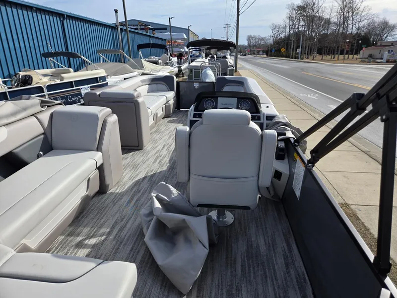 Slide: The Image of 2025 Godfrey Sweetwater 2286 C pontoon boat interior with plush seating and modern dashboard. - 24