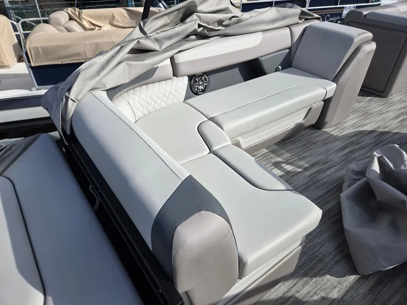 Slide: The Image of 2025 Godfrey Sweetwater 2286 C boat interior with gray seating and protective cover. - 25