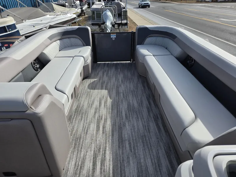 Slide: The Image of 2025 Godfrey Sweetwater 2286 C pontoon boat interior with gray seating and carpet. - 28
