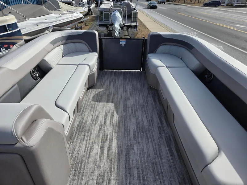 Slide: The Image of 2025 Godfrey Sweetwater 2286 C pontoon boat interior with gray seating and carpet. - 31
