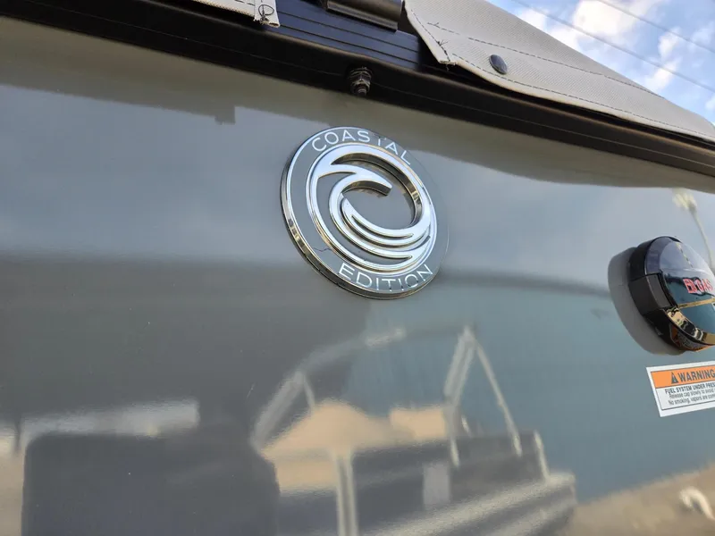 Slide: The Image of 2025 Godfrey Sweetwater 2286 C Coastal Edition emblem on boat exterior. - 35