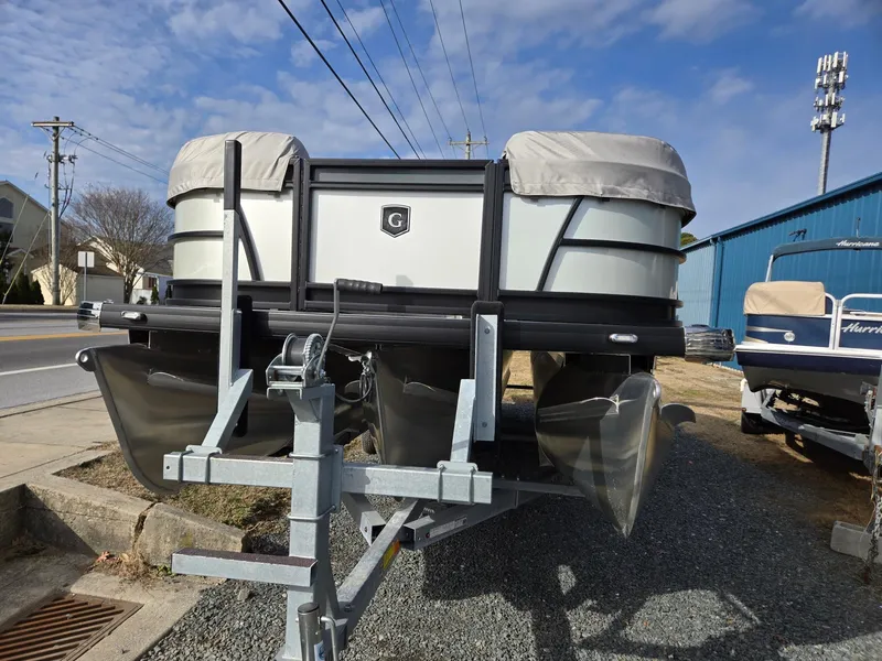 Slide: The Image of 2025 Godfrey Sweetwater 2286 C pontoon boat on trailer, parked outdoors. - 7