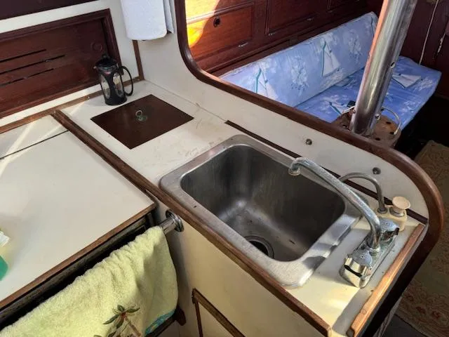 Slide: The Image of Galley of 1980 Cape Dory 36 sailboat with sink and seating area. - 10