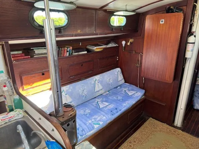 Slide: The Image of Interior of 1980 Cape Dory 36 sailboat with cozy seating and wooden cabinetry. - 16