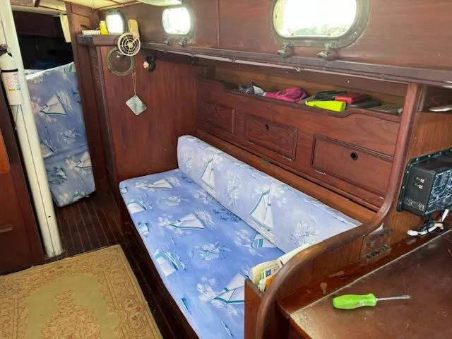 Slide: The Image of Interior of 1980 Cape Dory 36 sailboat with blue sailboat-patterned cushions. - 17