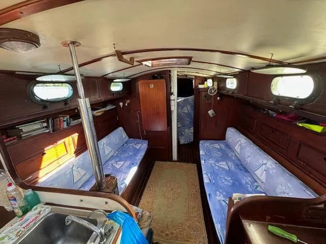 Slide: The Image of Interior of 1980 Cape Dory 36 sailboat with cozy seating and wooden finishes. - 18