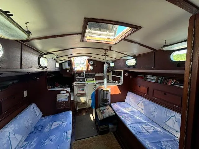 Slide: The Image of Interior of 1980 Cape Dory 36 sailboat with cozy seating and nautical decor. - 21