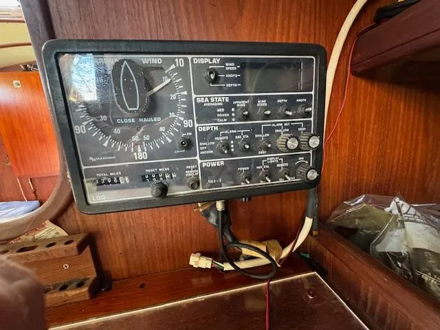 Slide: The Image of Control panel of a 1980 Cape Dory 36 sailboat, featuring navigation and depth instruments. - 24