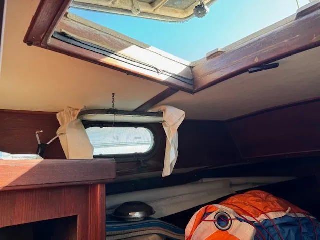 Slide: The Image of Interior cabin view of a 1980 Cape Dory 36 sailboat with open hatch. - 7