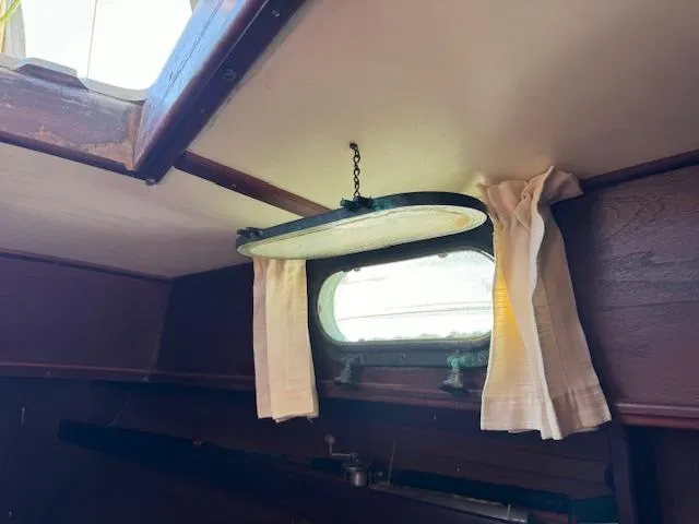Slide: The Image of Interior of 1980 Cape Dory 36 sailboat with porthole and curtains. - 8