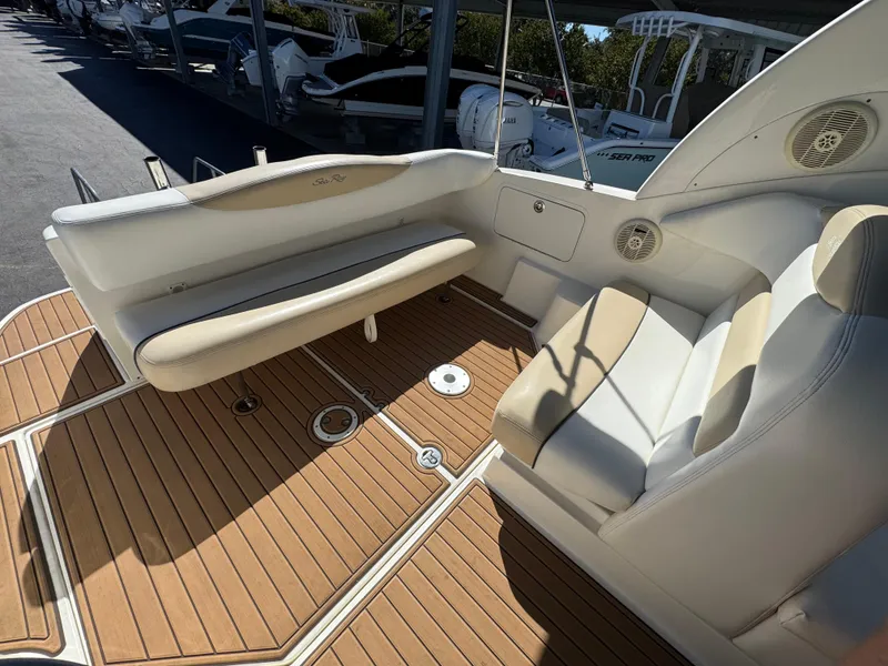 Slide: The Image of 2008 Sea Ray 280 Sundancer boat interior with beige seating and teak flooring. - 10