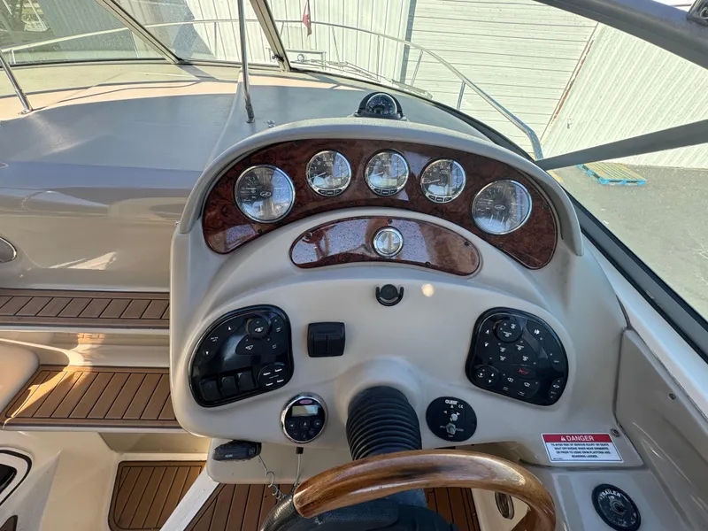 Slide: The Image of 2008 Sea Ray 280 Sundancer helm with wood accents and instrument panel. - 13