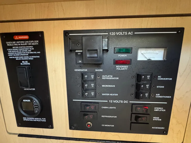 Slide: The Image of Control panel of a 2008 Sea Ray 280 Sundancer boat, showing AC and DC switches. - 23