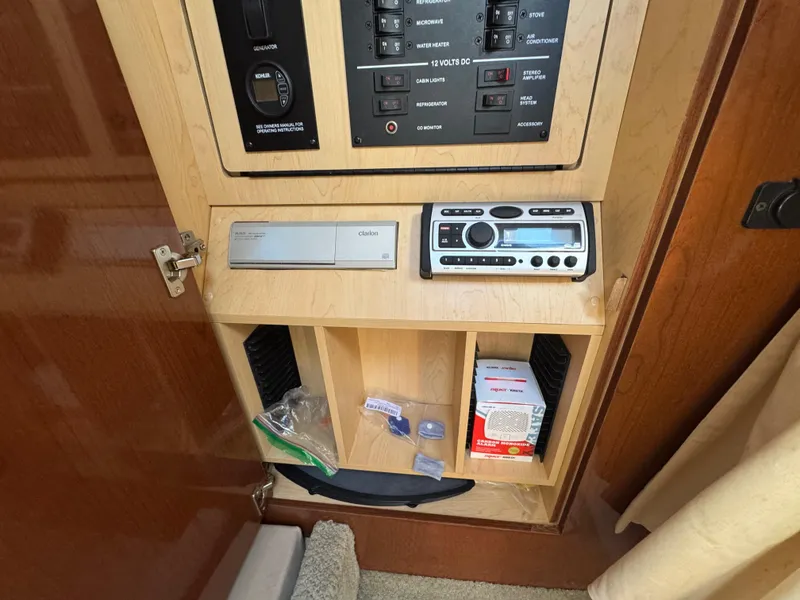 Slide: The Image of 2008 Sea Ray 280 Sundancer cabin control panel with stereo and storage compartments. - 24