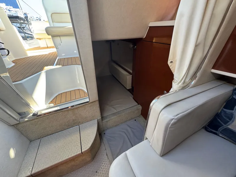 Slide: The Image of Interior cabin of 2008 Sea Ray 280 Sundancer with seating and storage. - 28