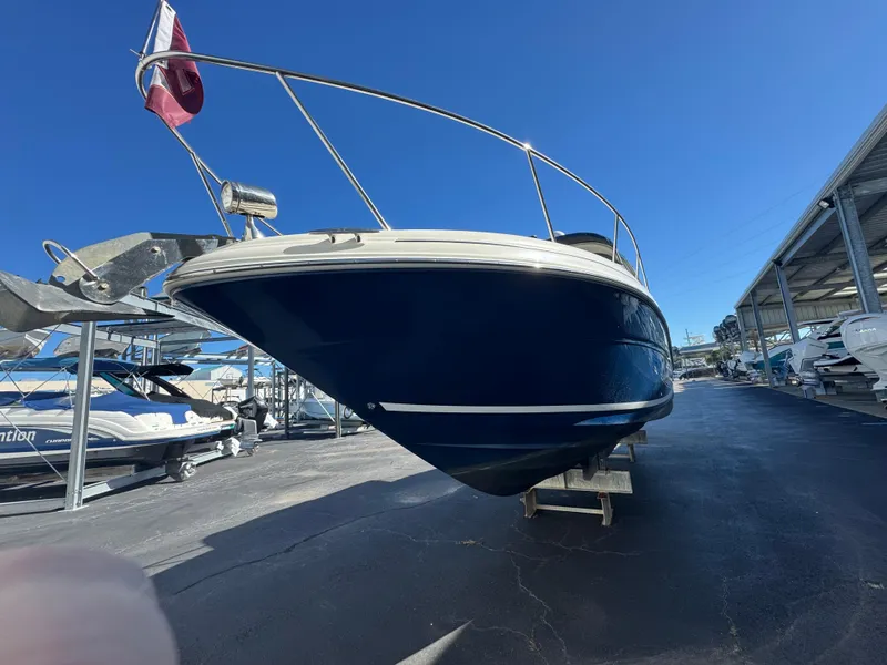 Slide: The Image of 2008 Sea Ray 280 Sundancer boat on display in a marina under clear blue sky. - 5